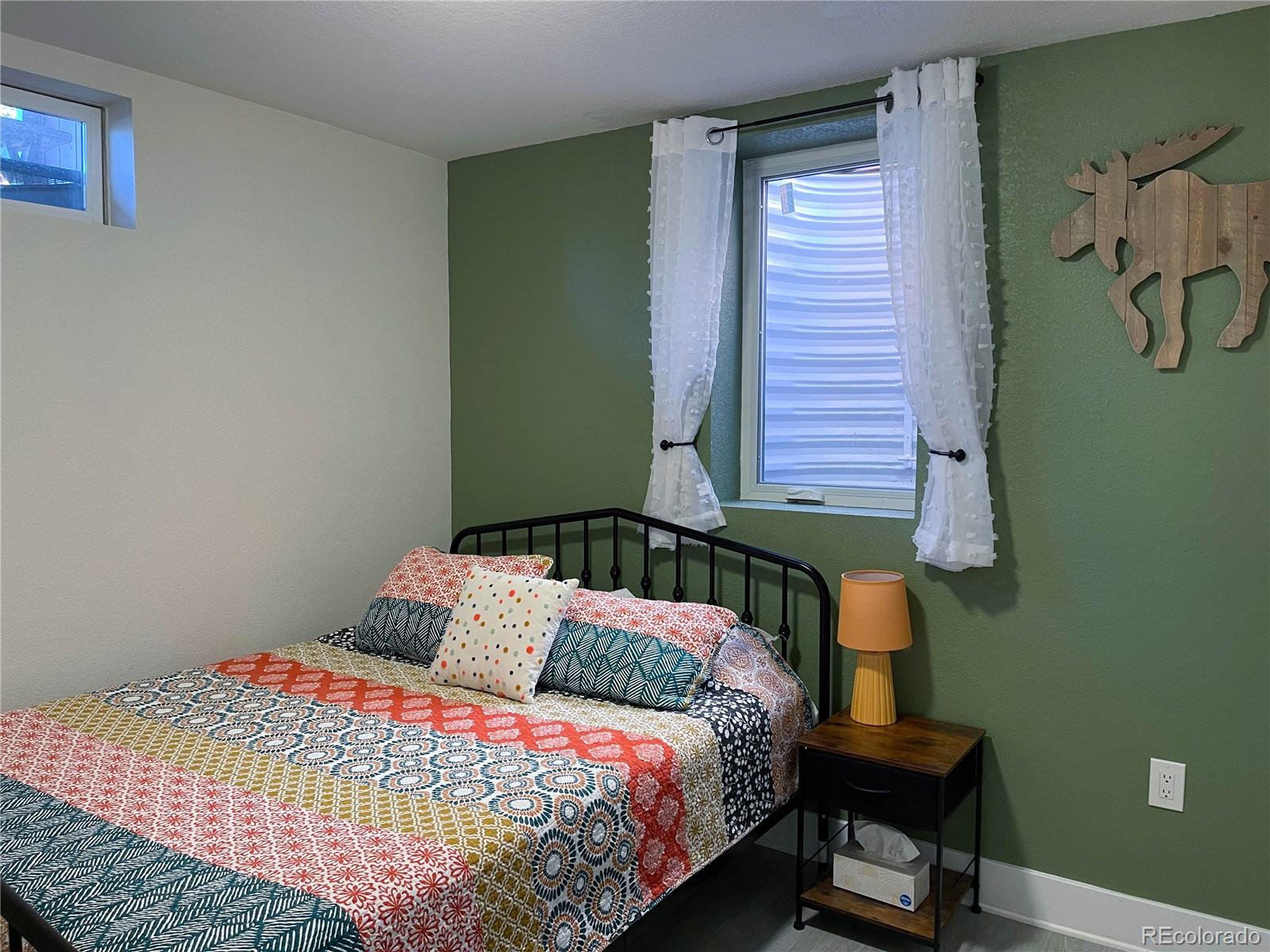 7051 Ruth Way Denver, CO 80221 - Photo 27 of 36 a bedroom with a bed and a window