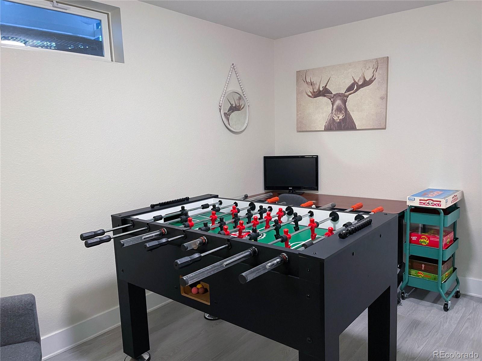 7051 Ruth Way Denver, CO 80221 - Photo 28 of 36 a room with toys and wooden floor