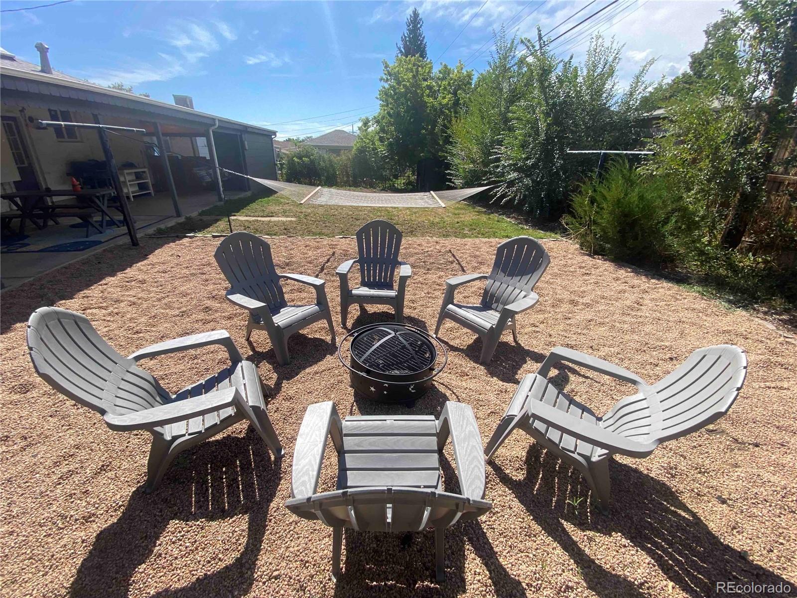 7051 Ruth Way Denver, CO 80221 - Photo 33 of 36 a view of a patio with table and chairs with wooden floor and fence