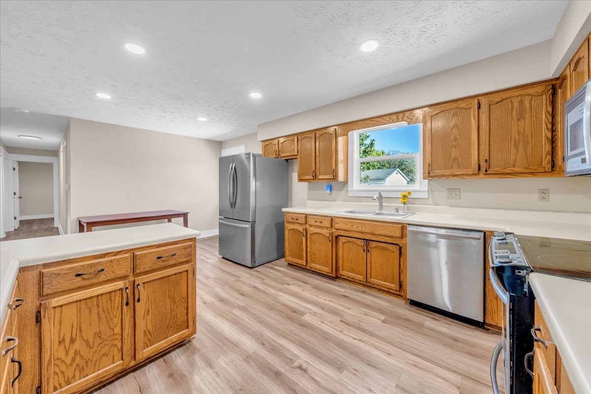 145 Hawkins Road Smithville, TN 37166 - Photo 12 of 45 a kitchen with wooden cabinets and white appliances