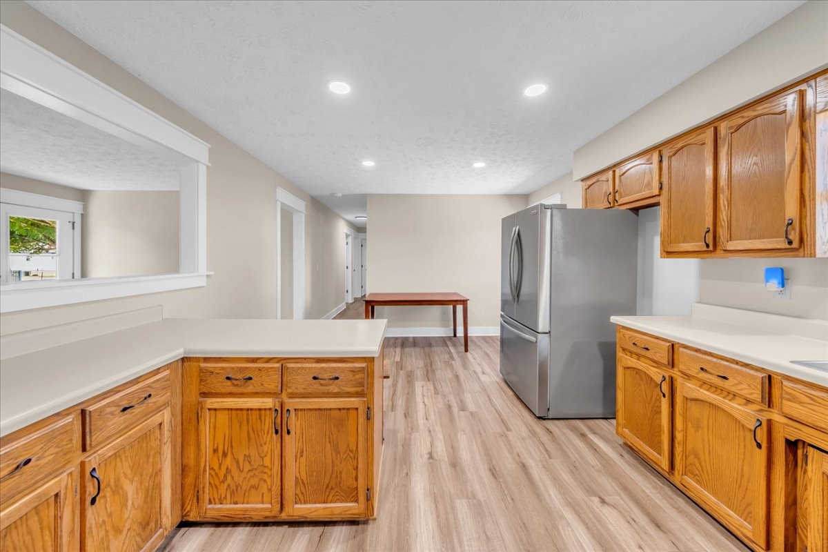 145 Hawkins Road Smithville, TN 37166 - Photo 15 of 45 a kitchen with stainless steel appliances granite countertop a refrigerator a sink dishwasher and wooden cabinets with wooden floor
