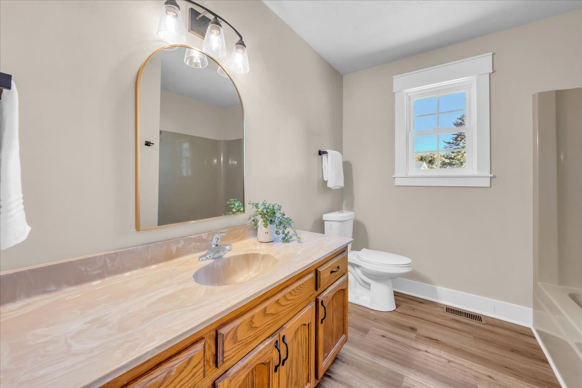 145 Hawkins Road Smithville, TN 37166 - Photo 17 of 45 a bathroom with a granite countertop sink a toilet and a mirror