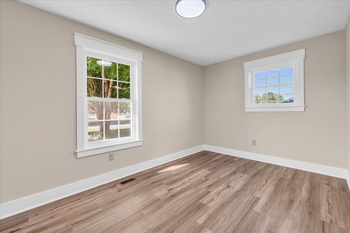 145 Hawkins Road Smithville, TN 37166 - Photo 20 of 45 an empty room with wooden floor and windows