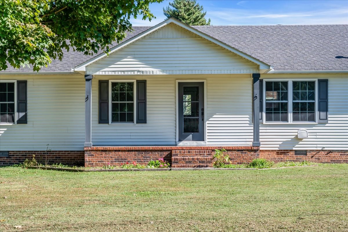 145 Hawkins Road Smithville, TN 37166 - Photo 5 of 45 a front view of a house with a yard