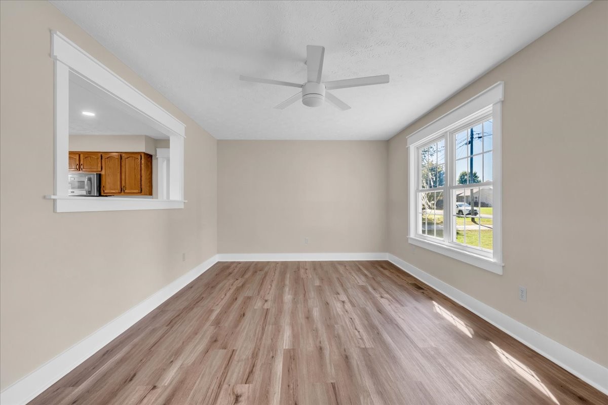 145 Hawkins Road Smithville, TN 37166 - Photo 8 of 45 a view of an empty room with wooden floor and a window