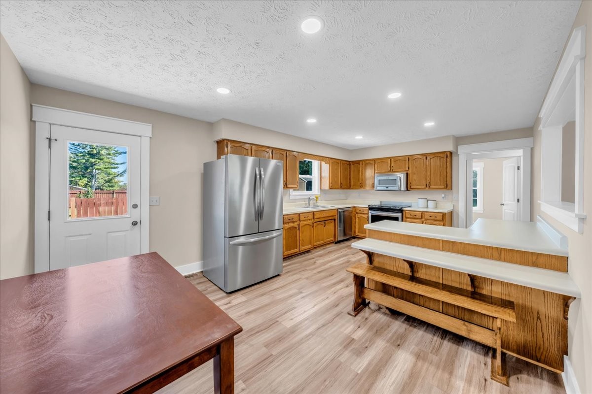 145 Hawkins Road Smithville, TN 37166 - Photo 10 of 45 a kitchen with stainless steel appliances a refrigerator and wooden floor