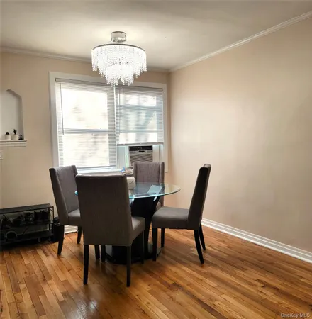 a dining room with furniture and wooden floor