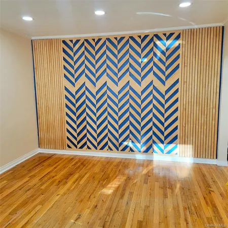 a view of a room with wooden floor and a shower curtain