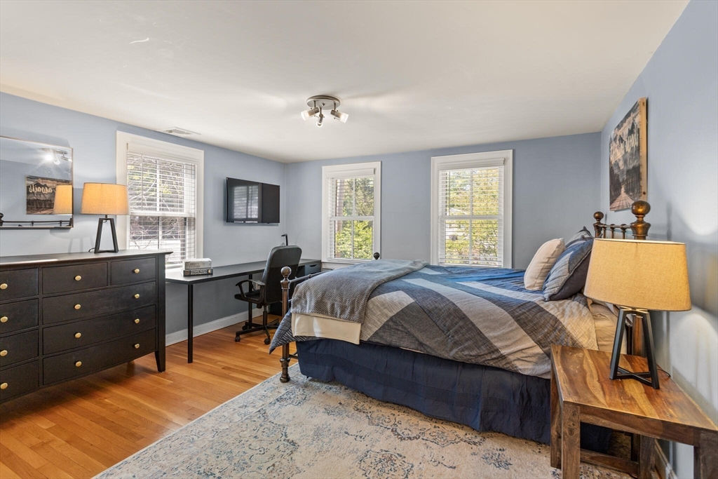 26 Stowell Road Winchester, MA 01890 - Photo 26 of 42 a bedroom with a bed and wooden floor