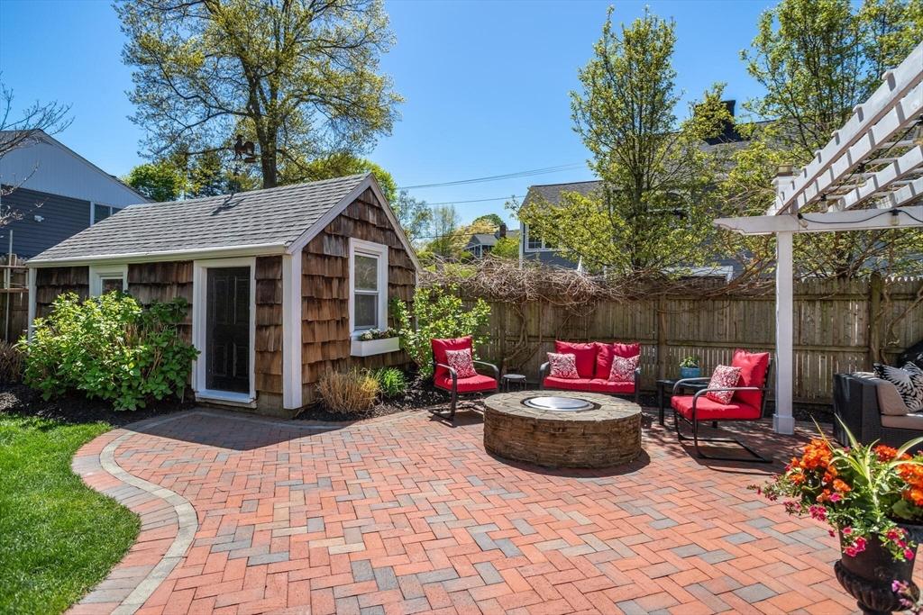 26 Stowell Road Winchester, MA 01890 - Photo 41 of 42 a view of a chairs and table in backyard of the house