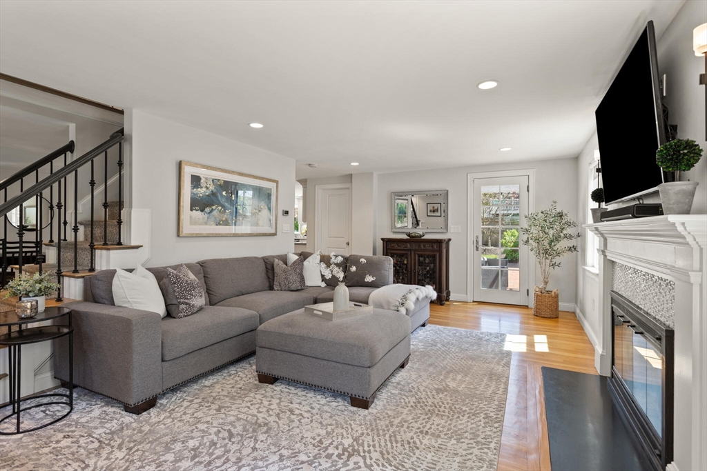 26 Stowell Road Winchester, MA 01890 - Photo 6 of 42 a living room with furniture a flat screen tv and a fireplace