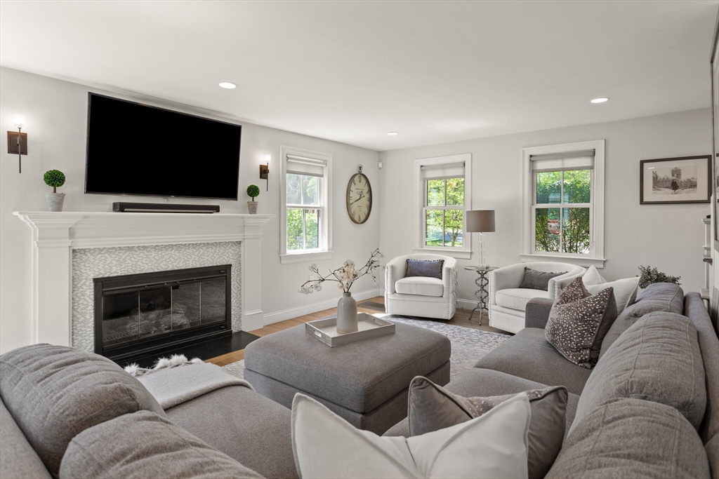 26 Stowell Road Winchester, MA 01890 - Photo 8 of 42 a living room with furniture a flat screen tv and a fireplace