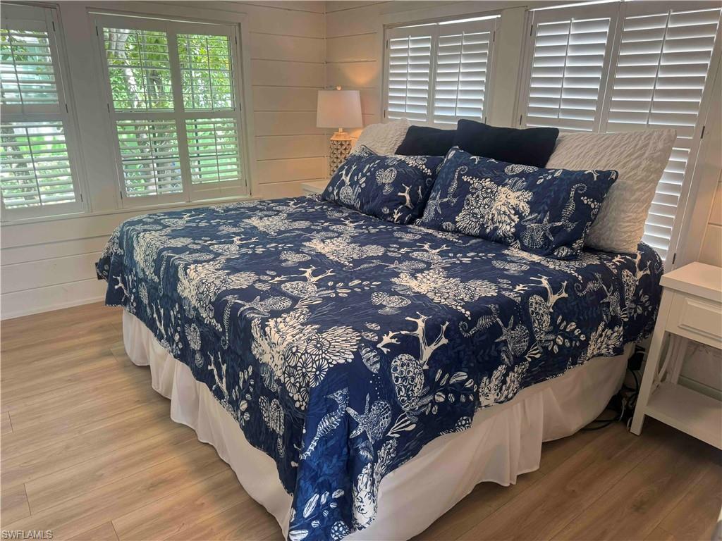 1012 Ridge Street Naples, FL 34103 - Photo 7 of 19 a large bed sitting in a bedroom next to a window