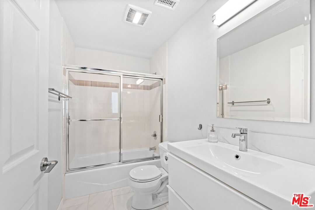 11535 Rochester Avenue, Unit 302 Los Angeles, CA 90025 - Photo 16 of 28 a bathroom with a sink toilet and shower
