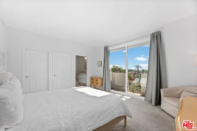 a bedroom with a large bed and a large window