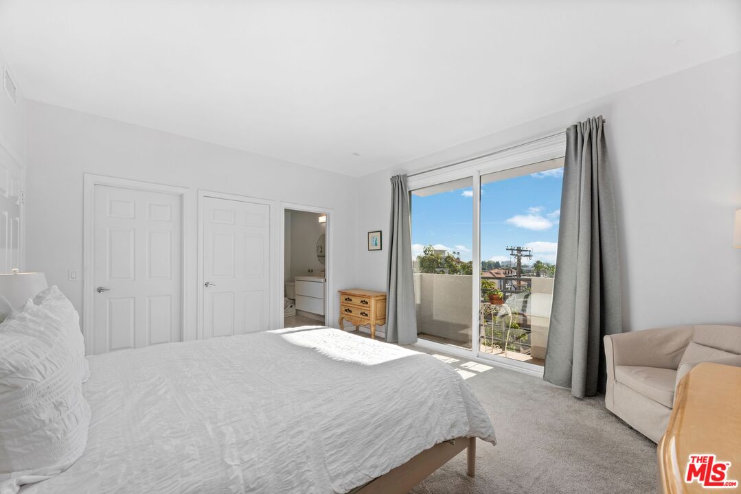 11535 Rochester Avenue, Unit 302 Los Angeles, CA 90025 - Photo 19 of 28 a bedroom with a large bed and a large window