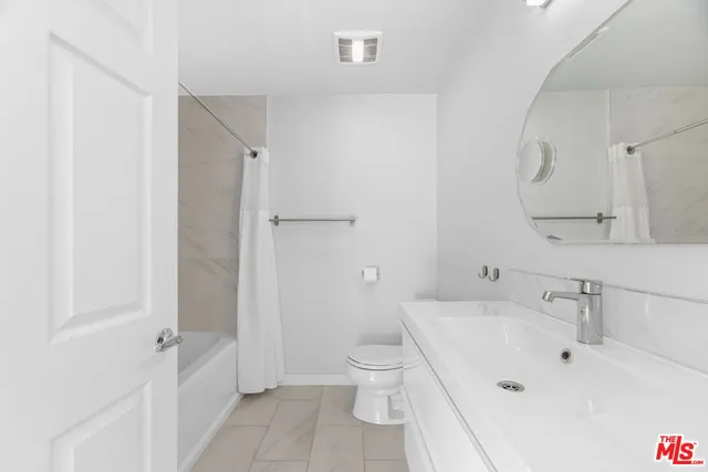 a bathroom with a sink and a large mirror