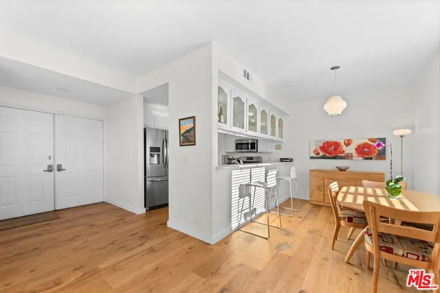 a open kitchen with stainless steel appliances granite countertop a refrigerator and a stove top oven