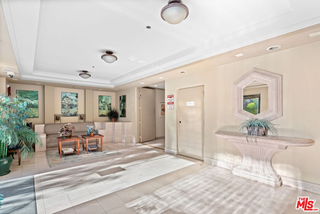 11535 Rochester Avenue, Unit 302 Los Angeles, CA 90025 - Photo 28 of 28 a living room with furniture and a potted plant