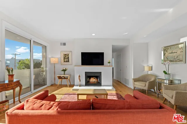 a living room with furniture fireplace and flat screen tv