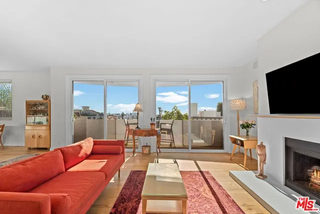 a living room with fireplace furniture and a flat screen tv