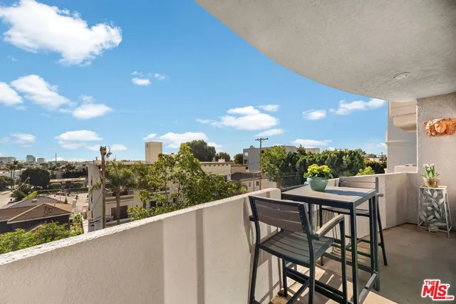 a view of a balcony dining table and chairs