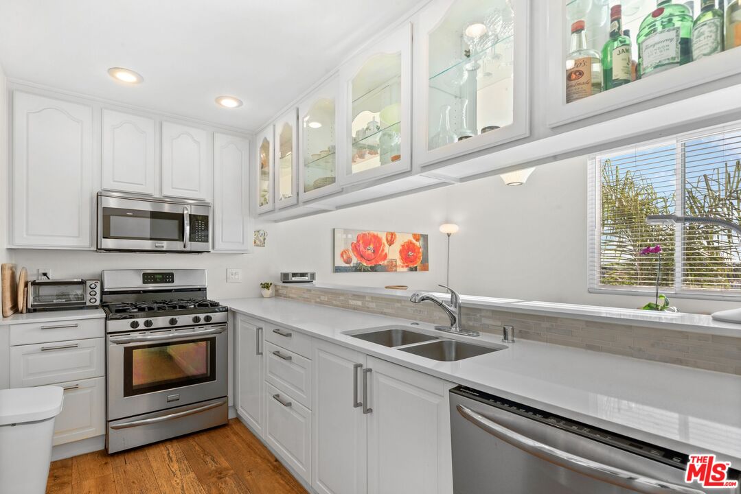 11535 Rochester Avenue, Unit 302 Los Angeles, CA 90025 - Photo 9 of 28 a kitchen with stainless steel appliances granite countertop a sink and a stove