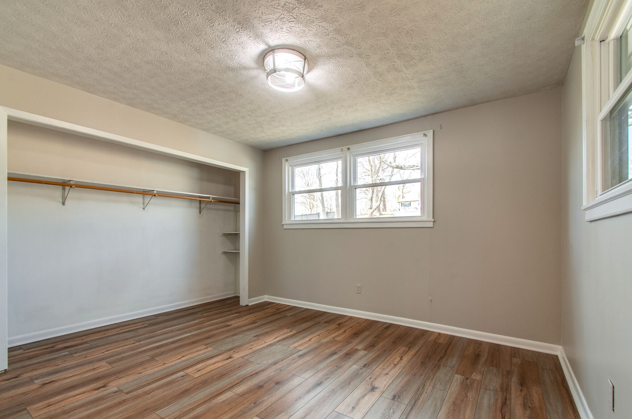 209 East Park Circle Dickson, TN 37055 - Photo 17 of 28 an empty room with wooden floor fan and windows