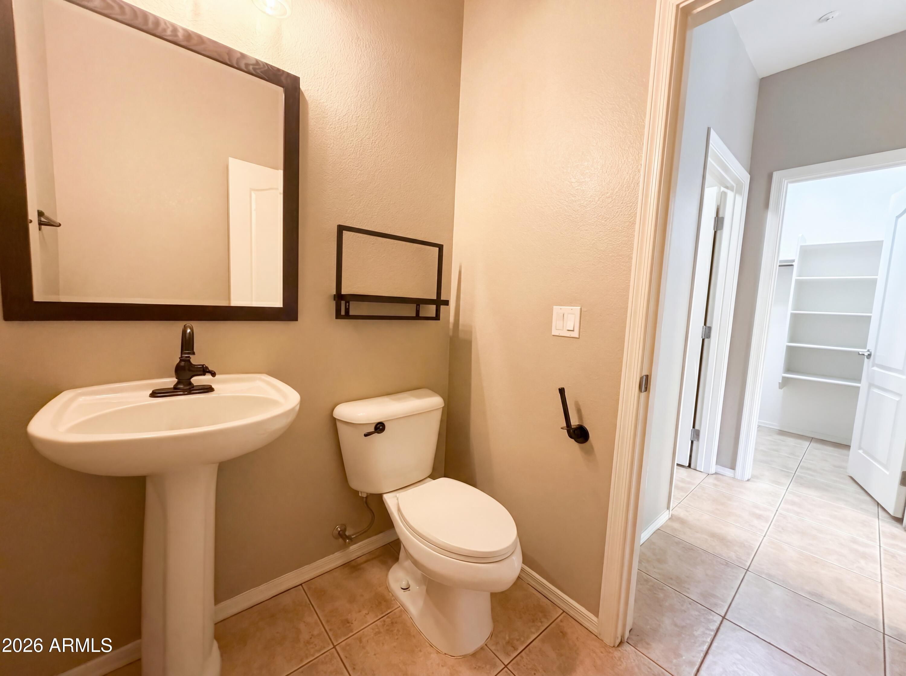 1565 East Hopkins Road Gilbert, AZ 85295 - Photo 24 of 29 a bathroom with a toilet sink and mirror