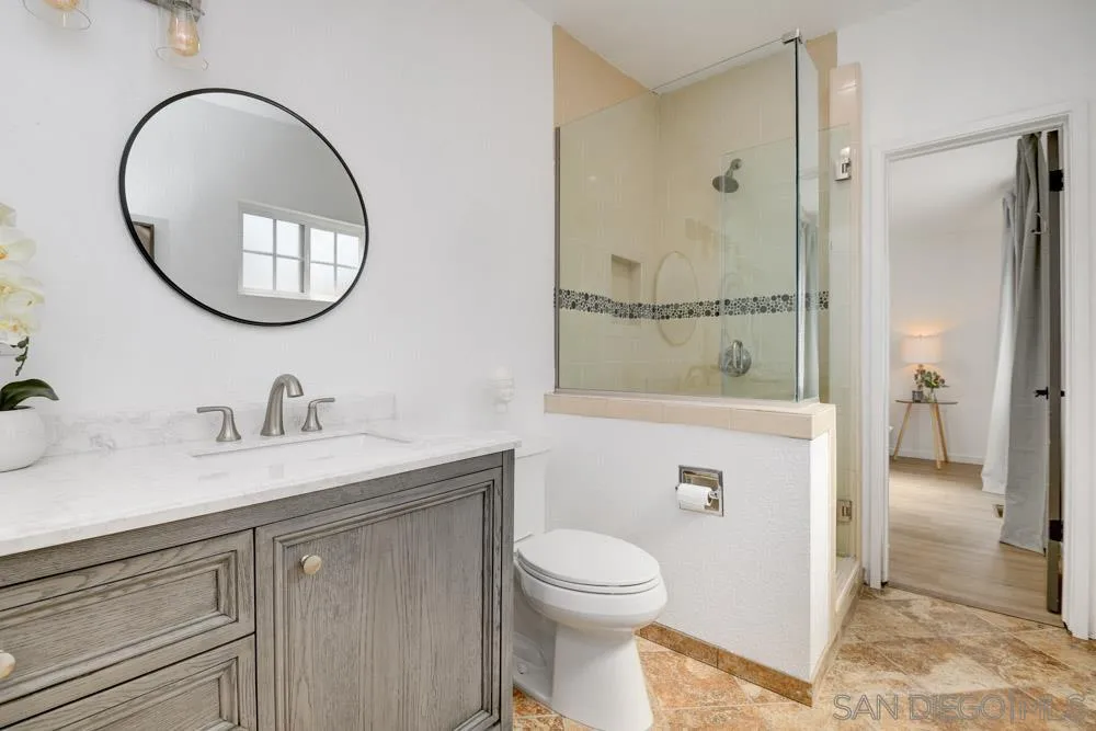 753 Farview Street El Cajon, CA 92021 - Photo 18 of 26 a bathroom with a granite countertop sink a mirror and a shower