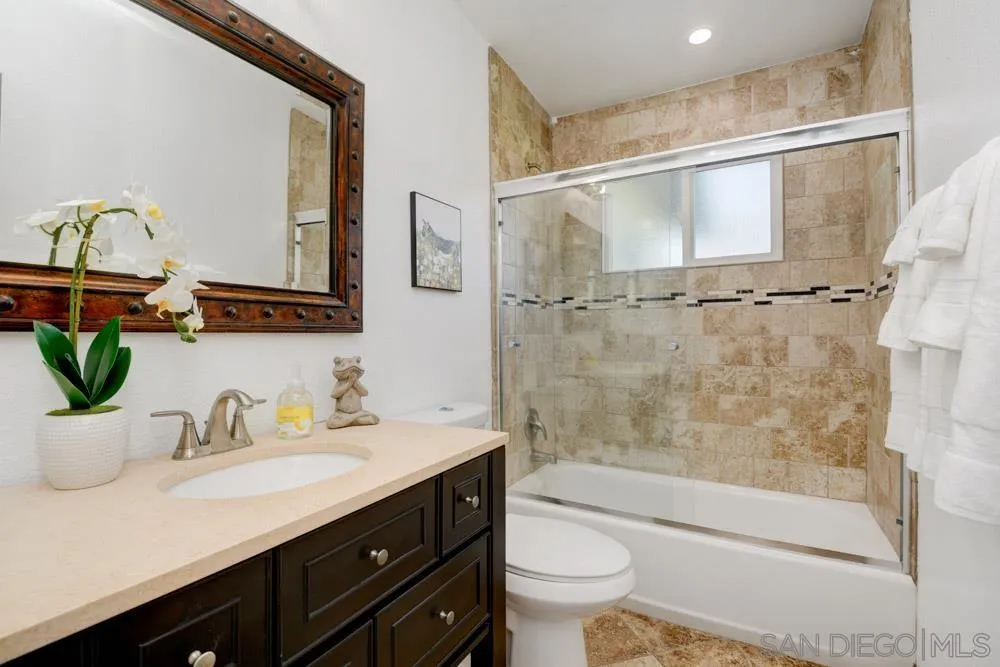 753 Farview Street El Cajon, CA 92021 - Photo 19 of 26 a bathroom with a shower sink vanity mirror and toilet