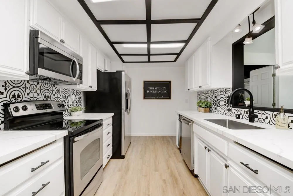 753 Farview Street El Cajon, CA 92021 - Photo 7 of 26 a kitchen with stainless steel appliances a stove sink microwave and cabinets