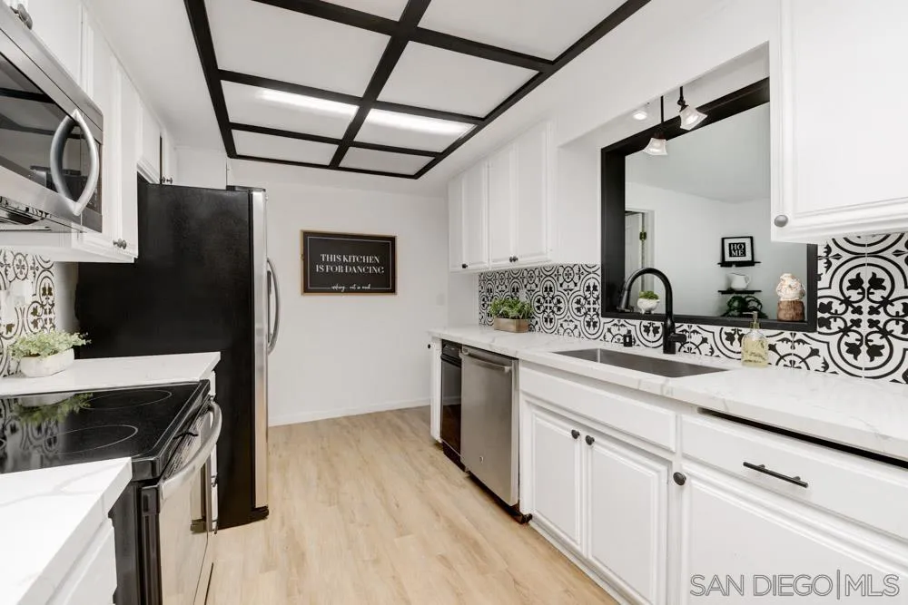 753 Farview Street El Cajon, CA 92021 - Photo 8 of 26 a kitchen with stainless steel appliances granite countertop a sink stove and refrigerator