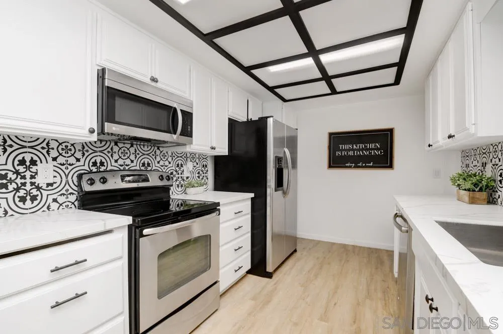 753 Farview Street El Cajon, CA 92021 - Photo 9 of 26 a kitchen with stainless steel appliances a stove microwave and refrigerator