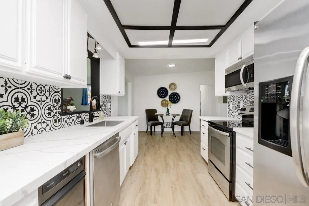 753 Farview Street El Cajon, CA 92021 - Photo 10 of 26 a kitchen with stainless steel appliances granite countertop sink stove top oven and cabinets