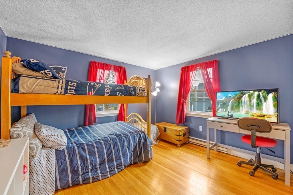 12 Pitman Road Marblehead, MA 01945 - Photo 16 of 28 a bedroom with furniture and a flat screen tv