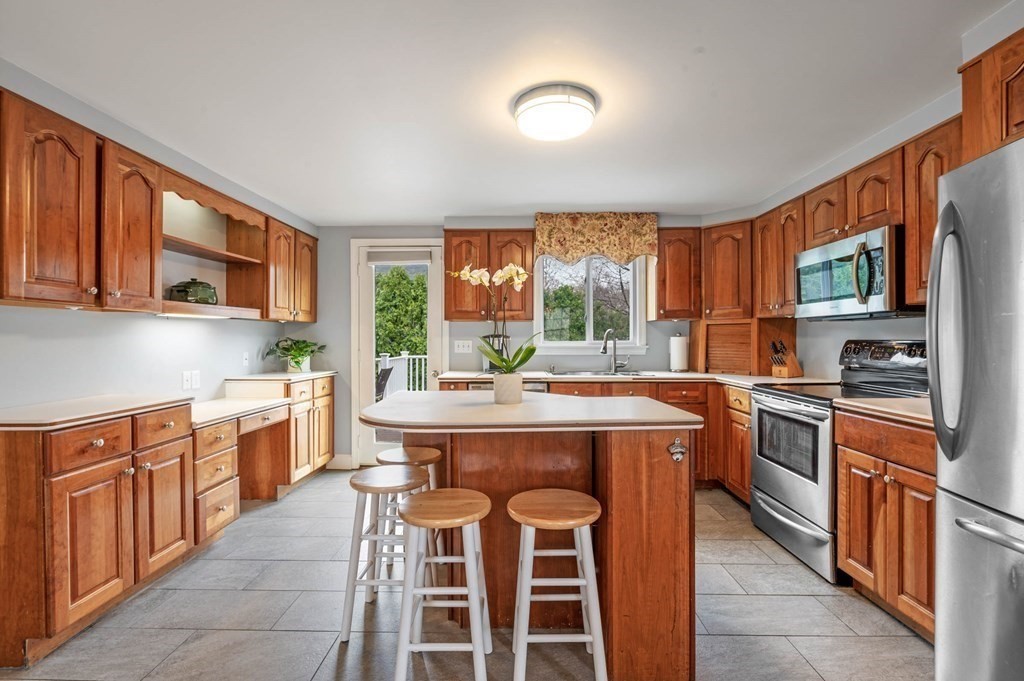 12 Pitman Road Marblehead, MA 01945 - Photo 9 of 28 a kitchen with a stove top oven sink and cabinets