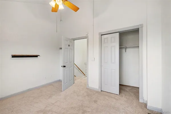 an empty room with closet and windows