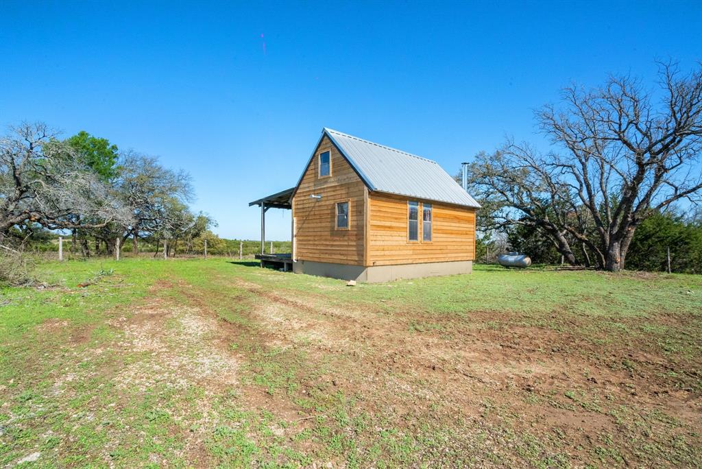 1012 Xxx County Road Bluff Dale, TX 76433 - Photo 7 of 19 a view of a house with yard and tree s