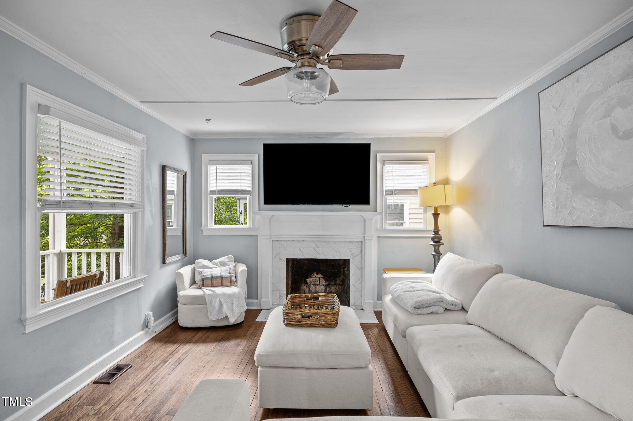 2721 Cartier Drive Raleigh, NC 27608 - Photo 15 of 44 a living room with furniture a fireplace and a flat screen tv
