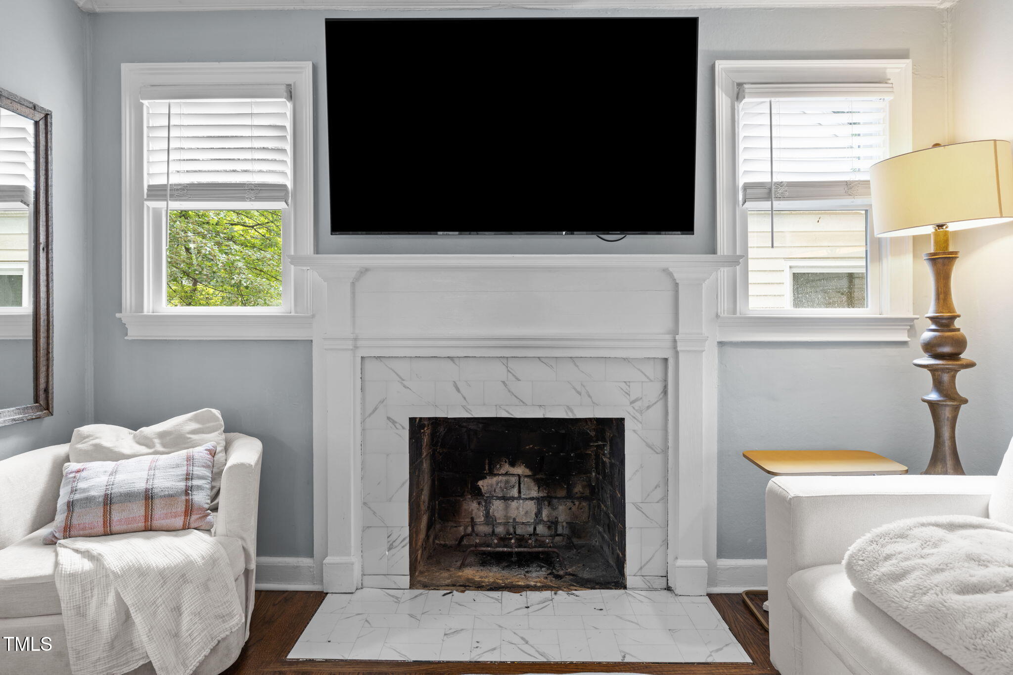 2721 Cartier Drive Raleigh, NC 27608 - Photo 17 of 44 a living room with furniture a flat screen tv and a fireplace