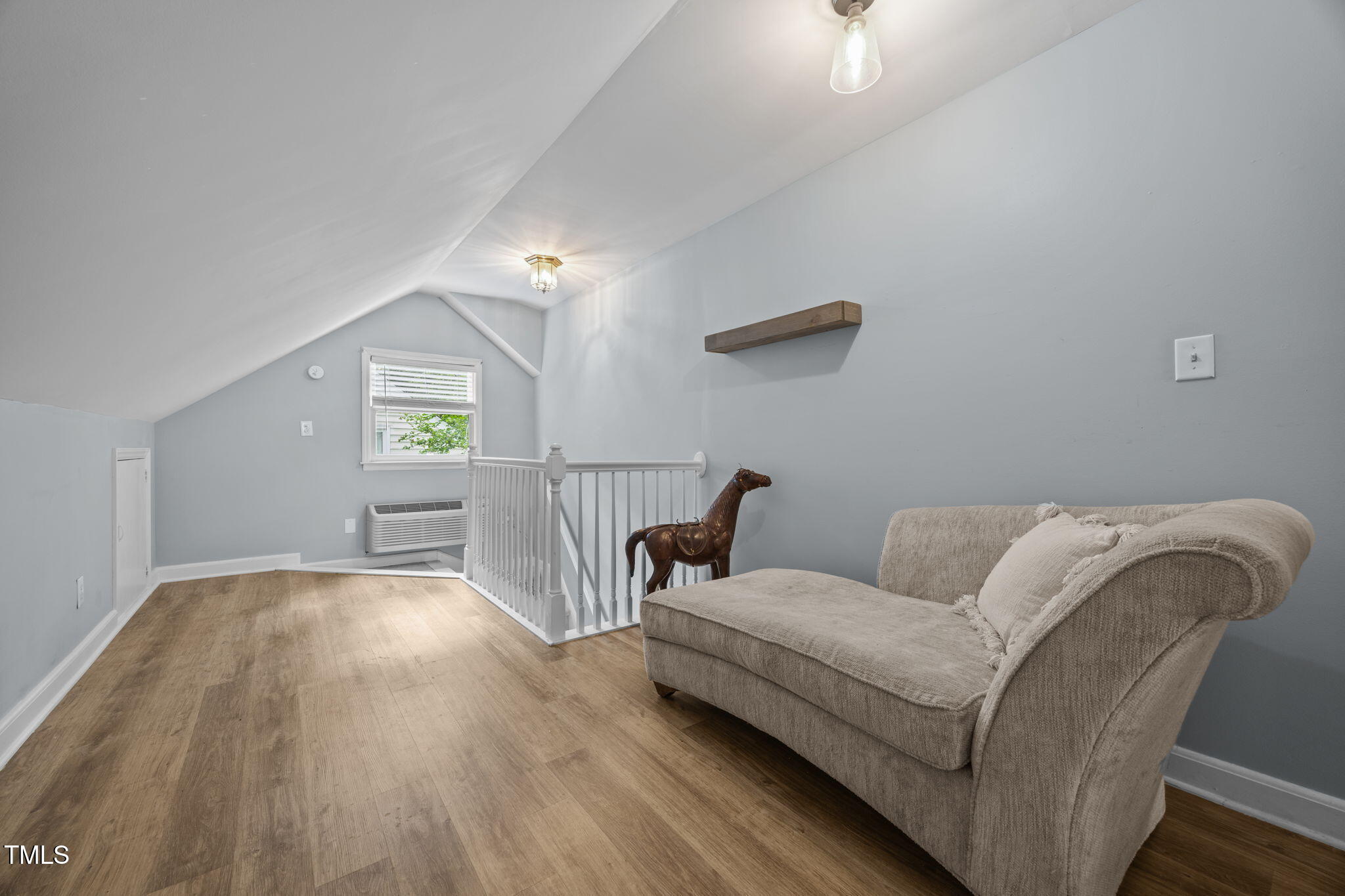 2721 Cartier Drive Raleigh, NC 27608 - Photo 20 of 44 a living room with furniture and a wooden floor