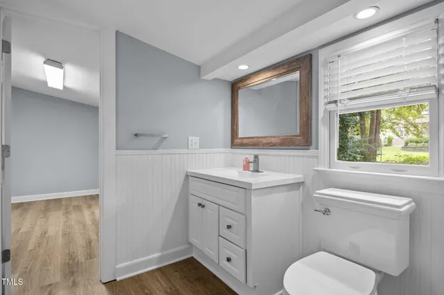 a bathroom with a toilet sink and mirror