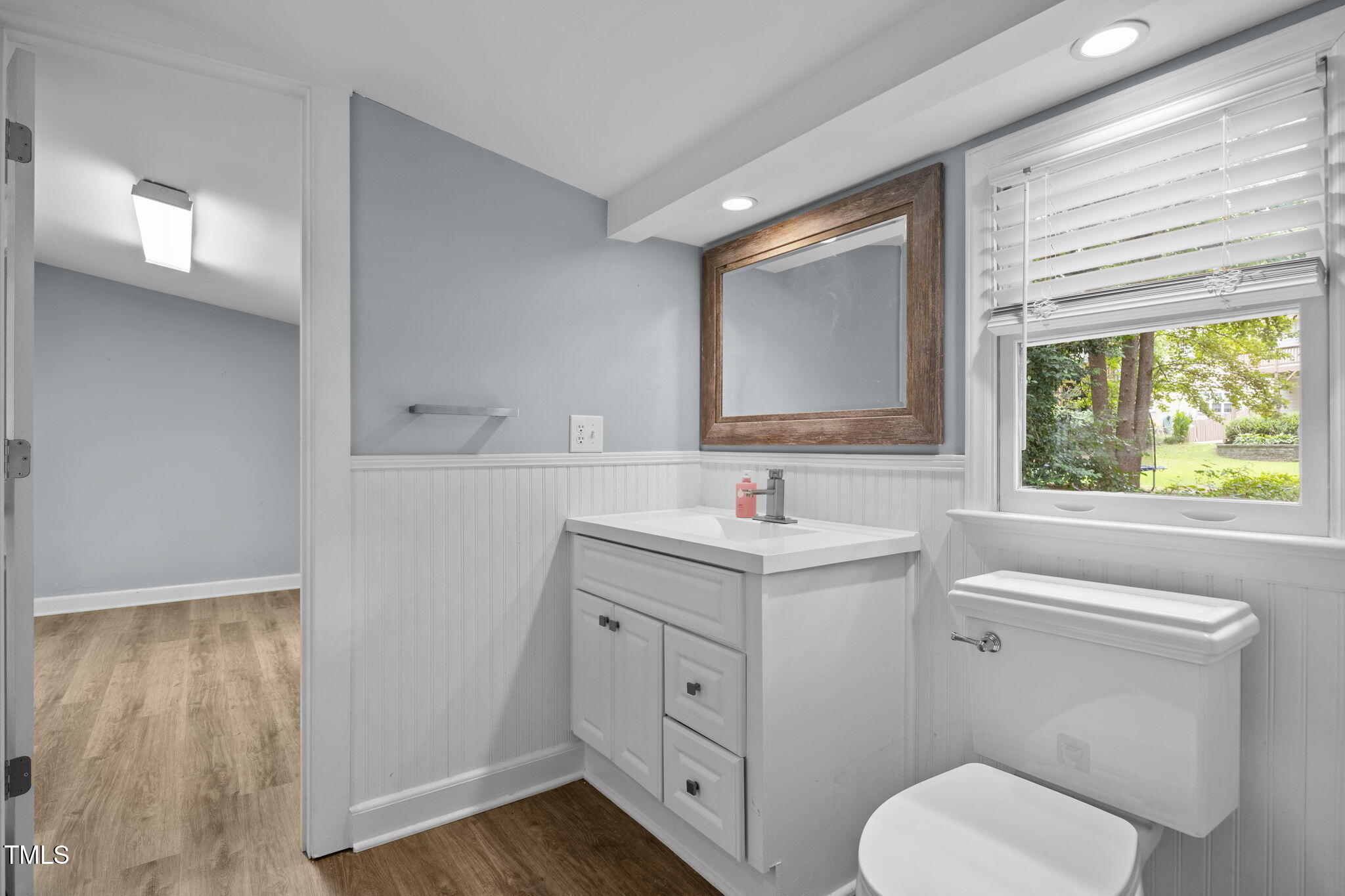 2721 Cartier Drive Raleigh, NC 27608 - Photo 22 of 44 a bathroom with a toilet sink and mirror