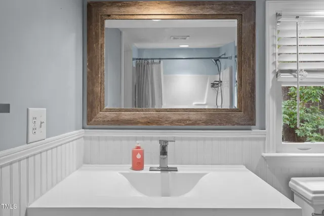 a bathroom with a sink and a mirror