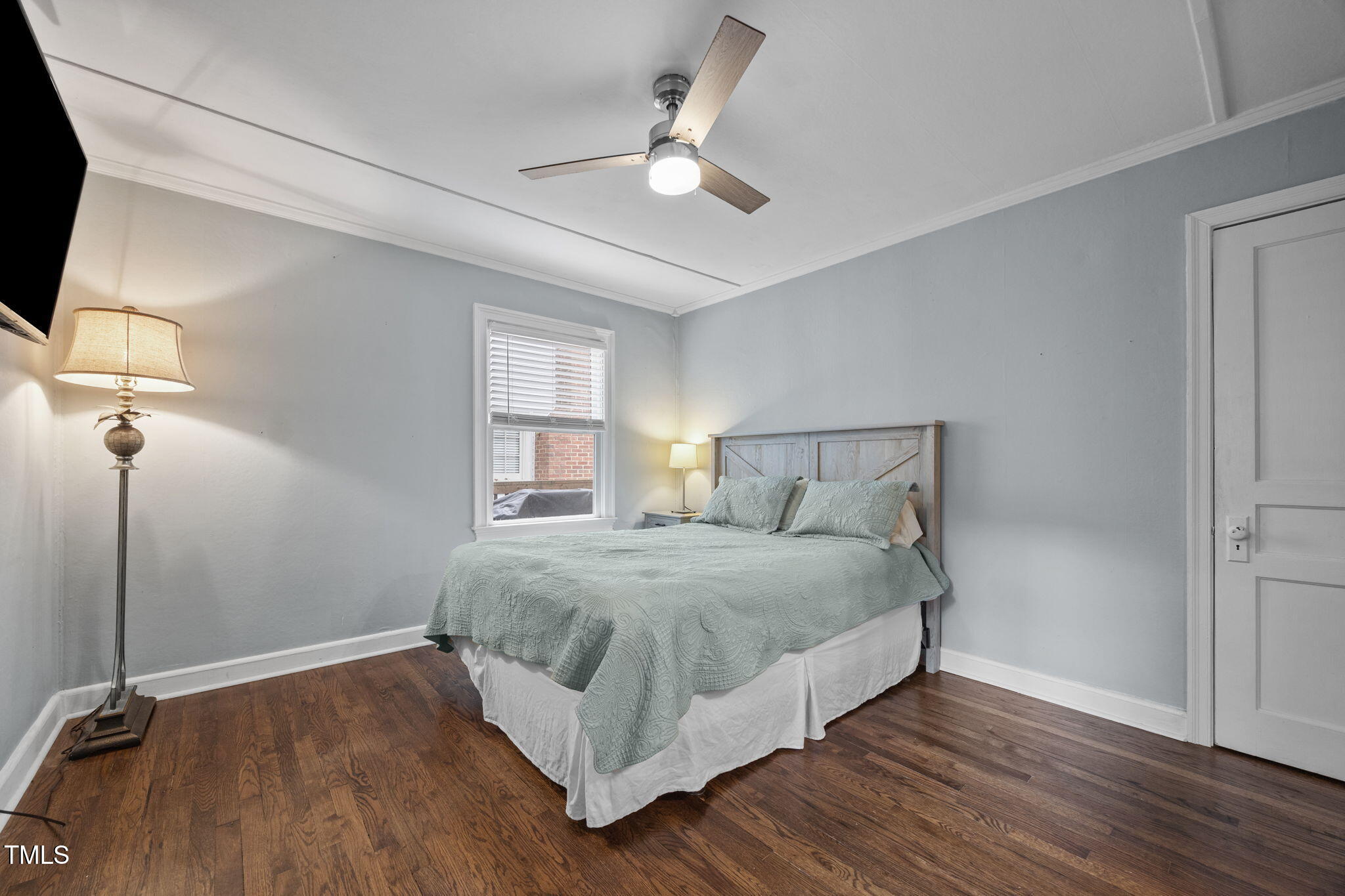 2721 Cartier Drive Raleigh, NC 27608 - Photo 28 of 44 a bedroom with a bed and a ceiling fan