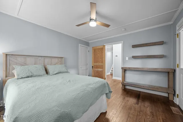 a bedroom with a bed and a ceiling fan
