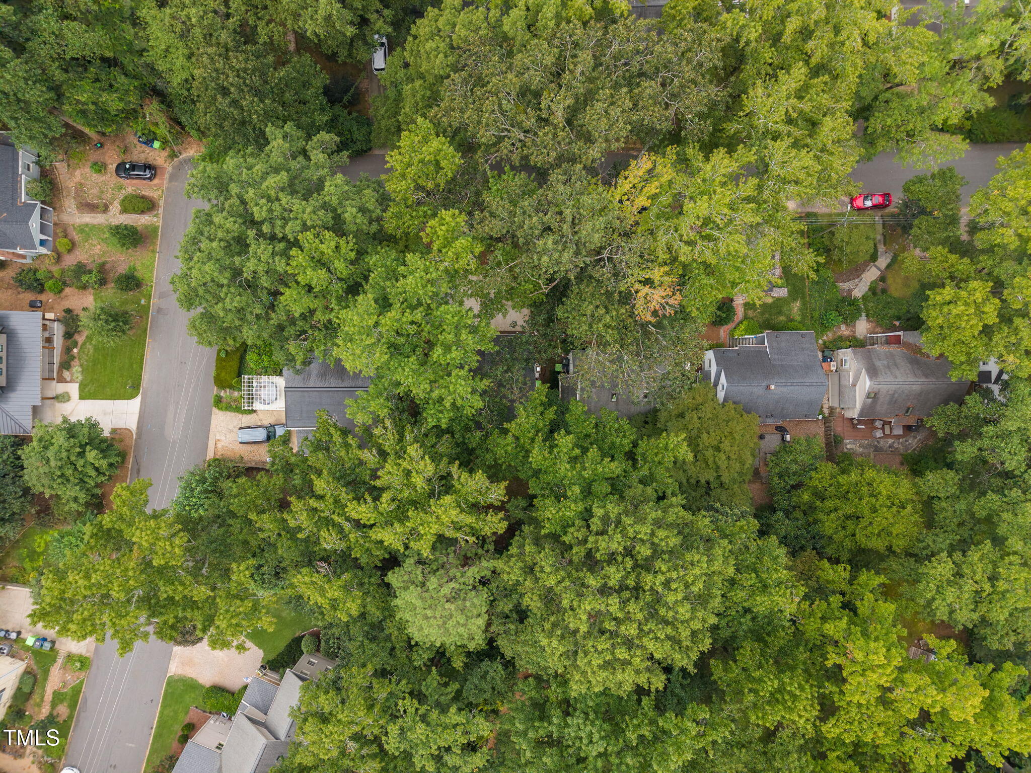 2721 Cartier Drive Raleigh, NC 27608 - Photo 41 of 44 an aerial view of a house with outdoor space and trees all around