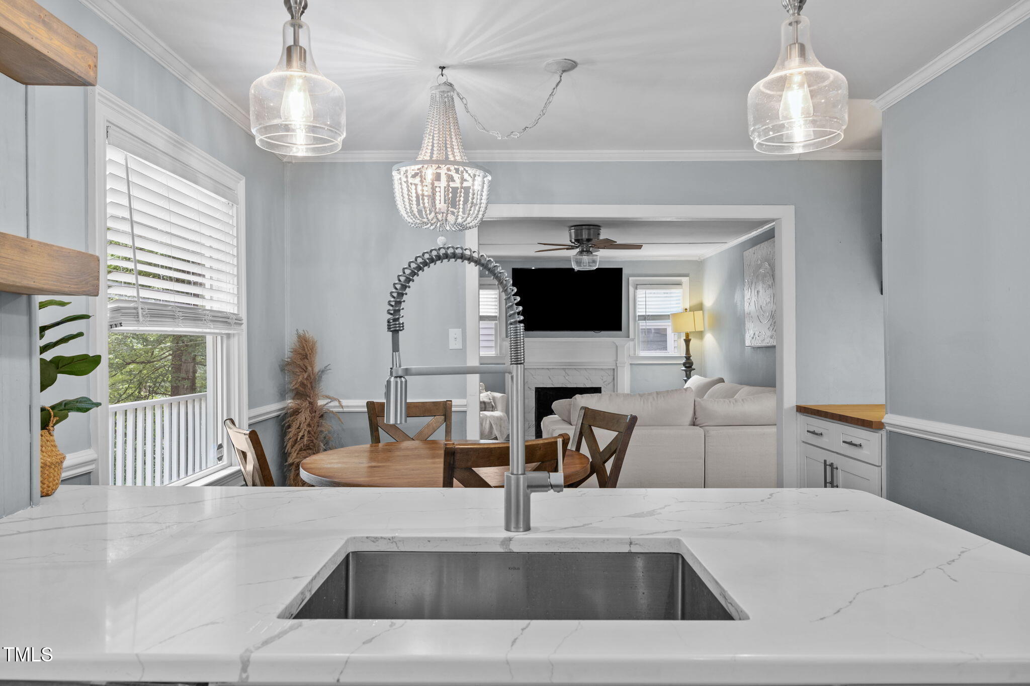 2721 Cartier Drive Raleigh, NC 27608 - Photo 9 of 44 a view of living room with furniture and chandelier