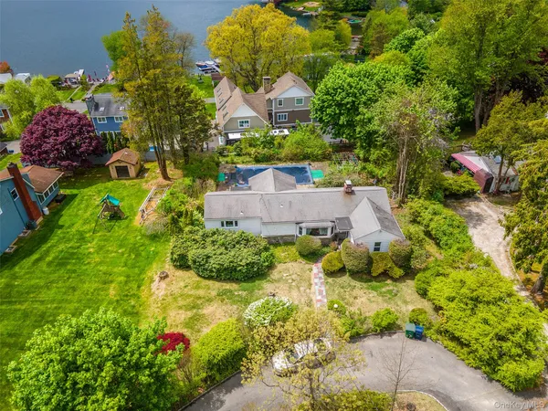 an aerial view of a house with a yard and garden